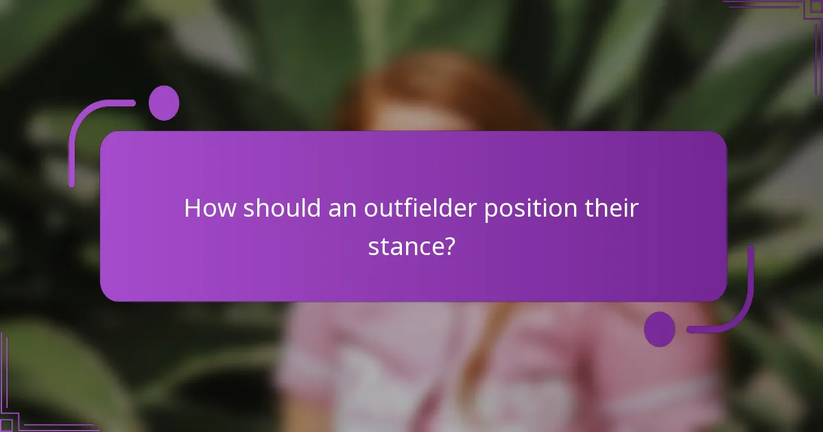 How should an outfielder position their stance?